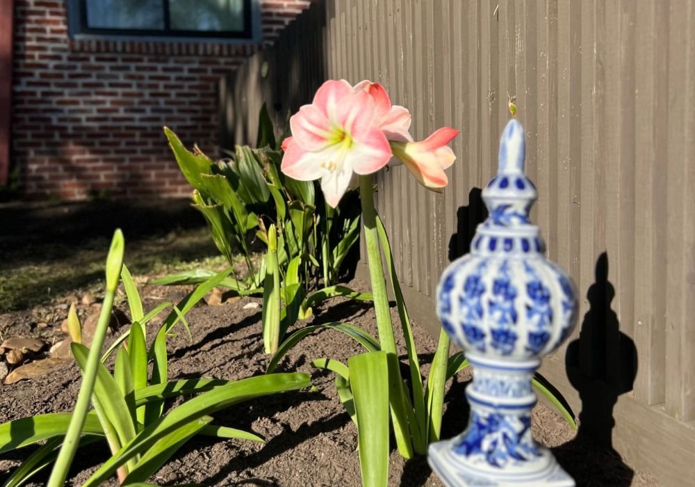 Landscape ornamental vase near spring blooms