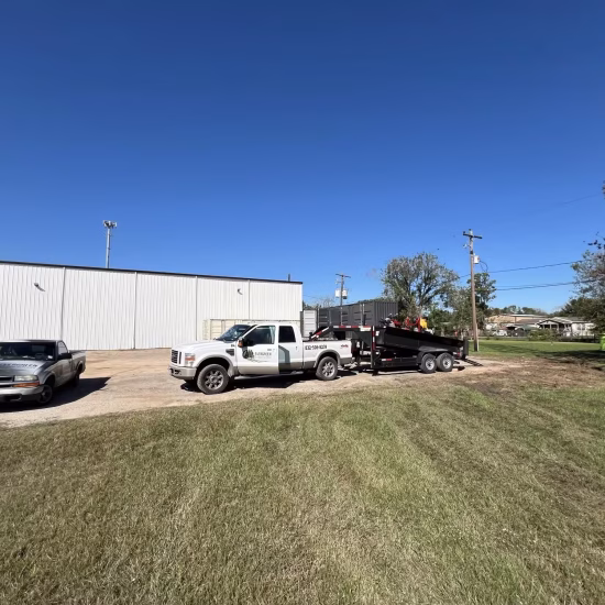 Commercial property cleanups in Houston underway, with a professional crew actively clearing debris and revitalizing the exterior of a business location.